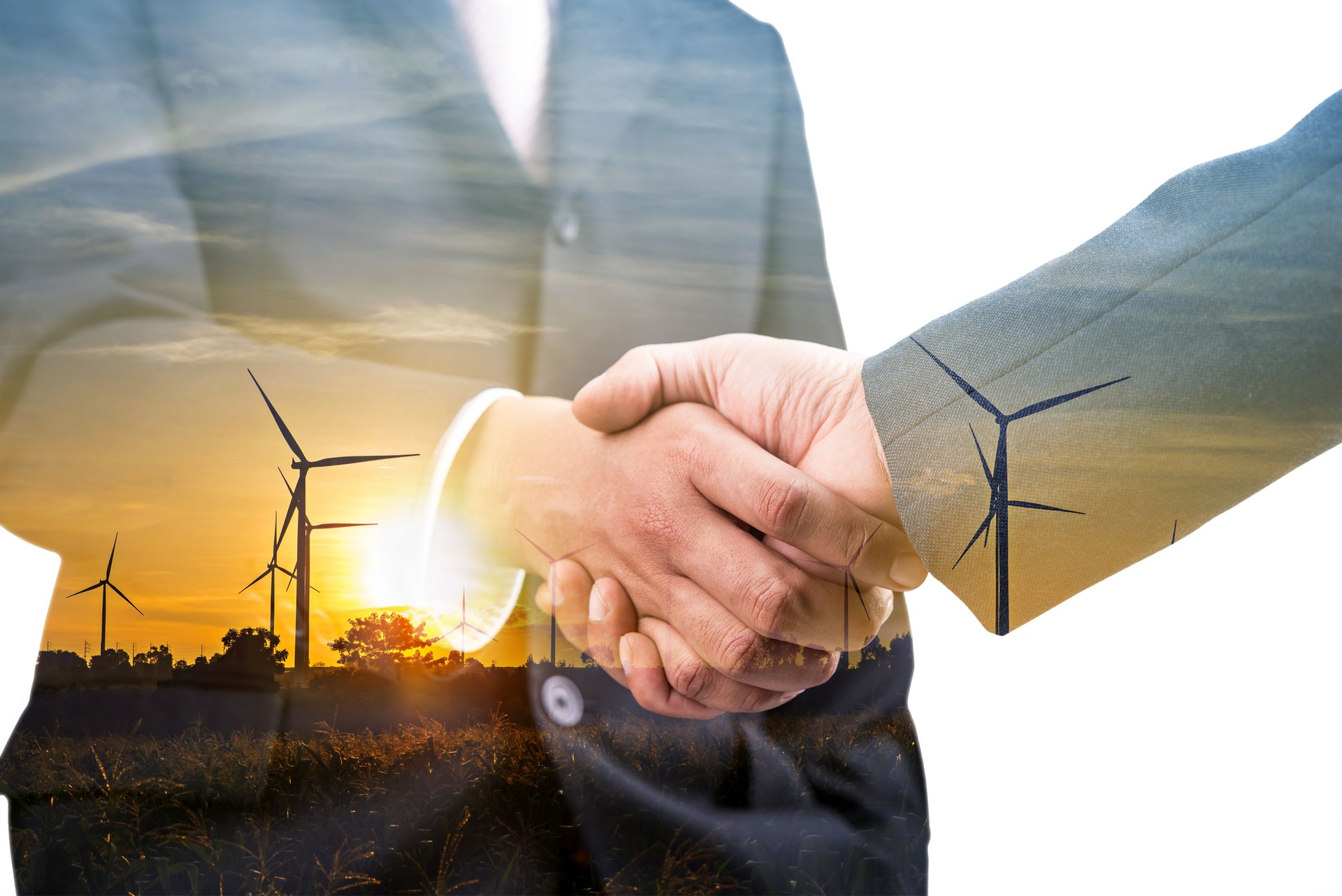 Double exposure of business handshake partnership with wind turbine farm plant background